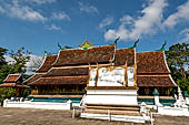 Wat Xieng Thong temple in Luang Prabang, Laos.  A view of the 'sim' with the large sweeping roof. 